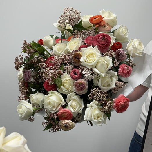 Bouquet of roses, ranunculus and flowering branches